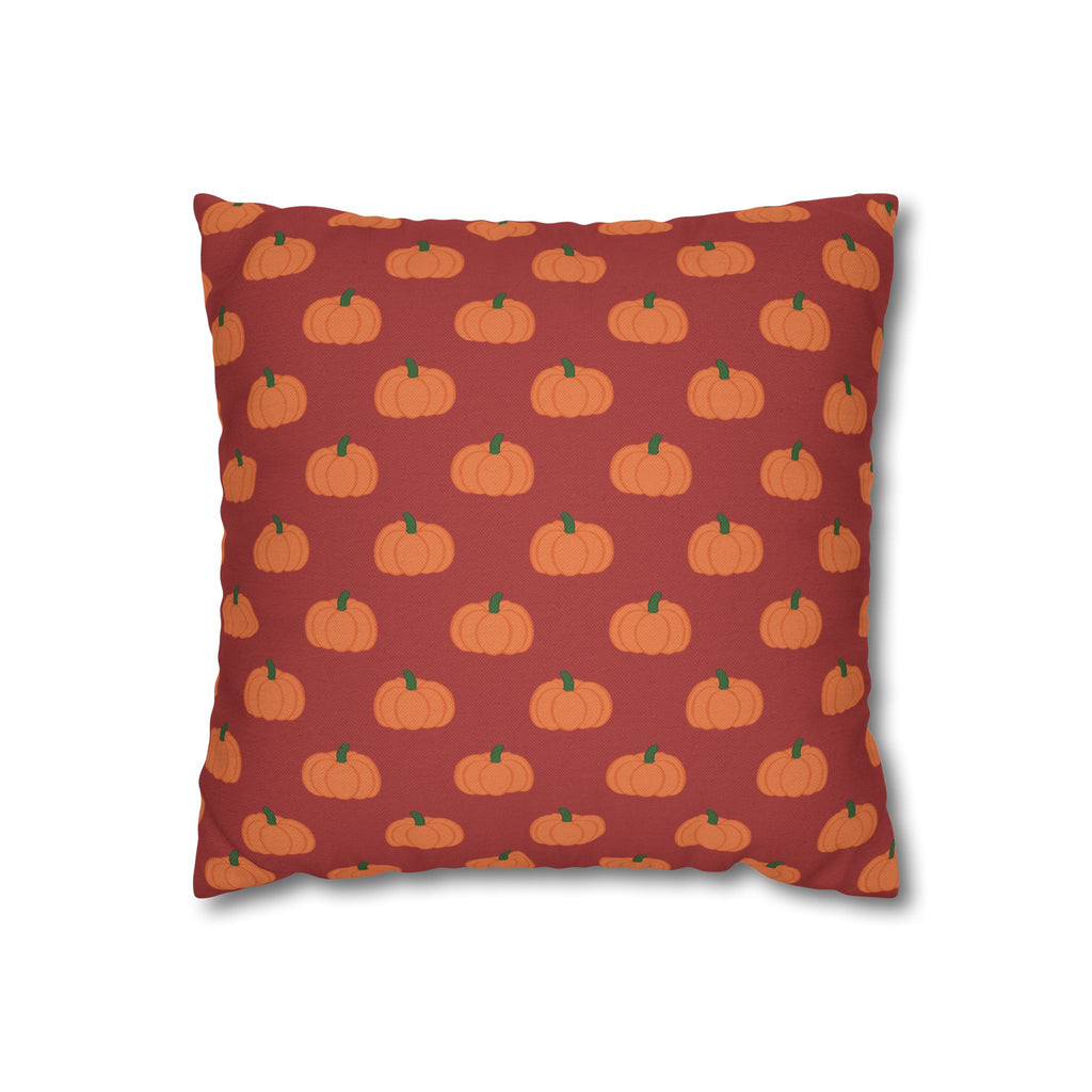 A square throw pillow featuring orange pumpkins on a burnt orange background