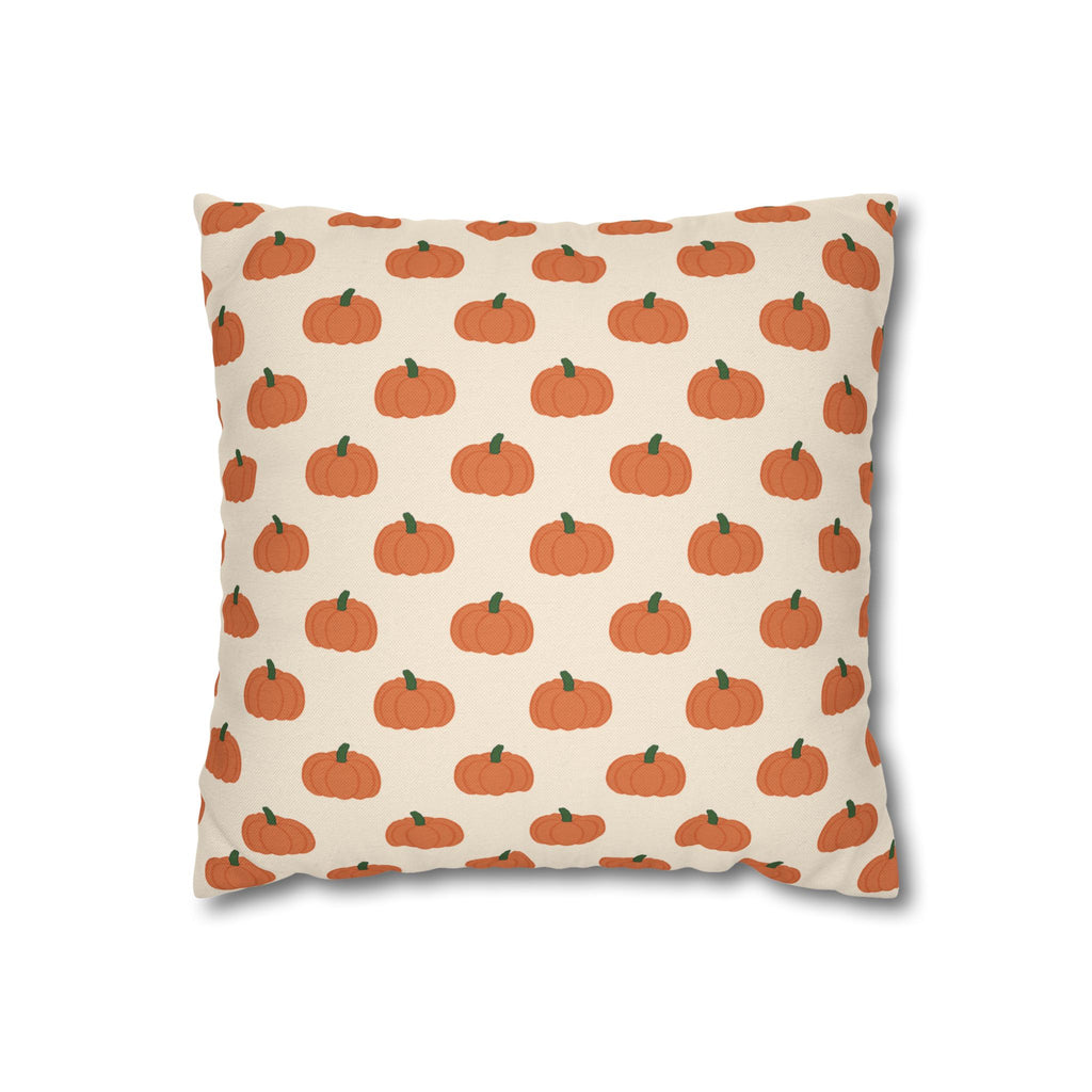 A square throw pillow featuring a repeating pattern of small orange pumpkins with green stems on a cream background.